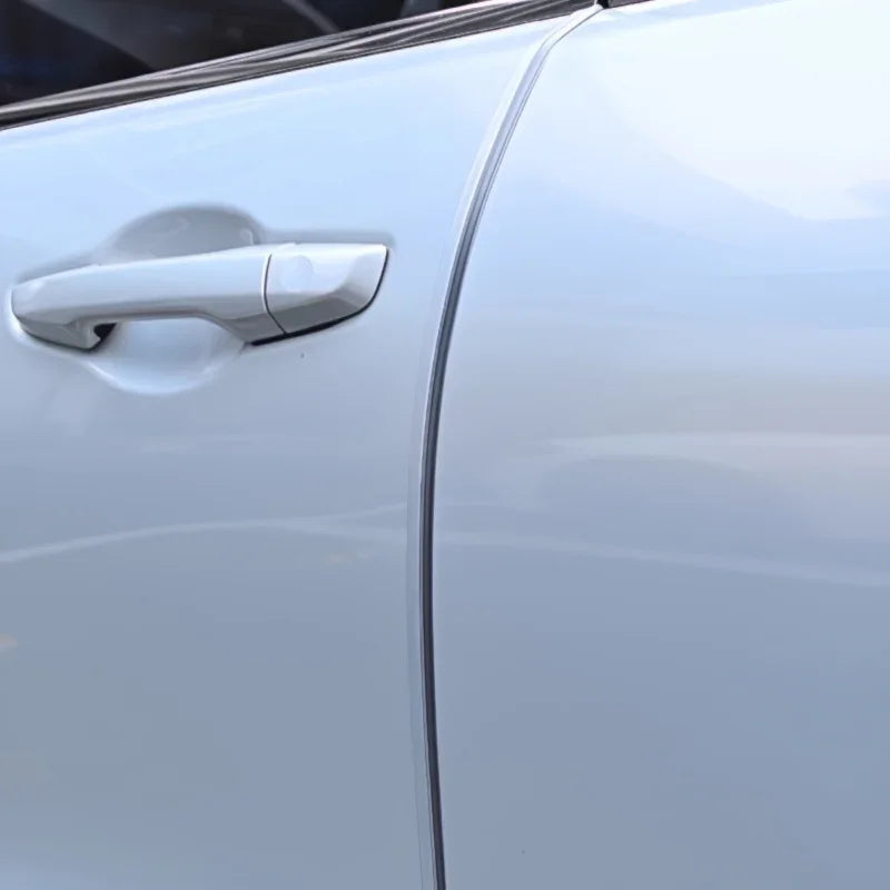 Close-up of a sleek, silver-colored car door handle with a smooth, metallic finish.