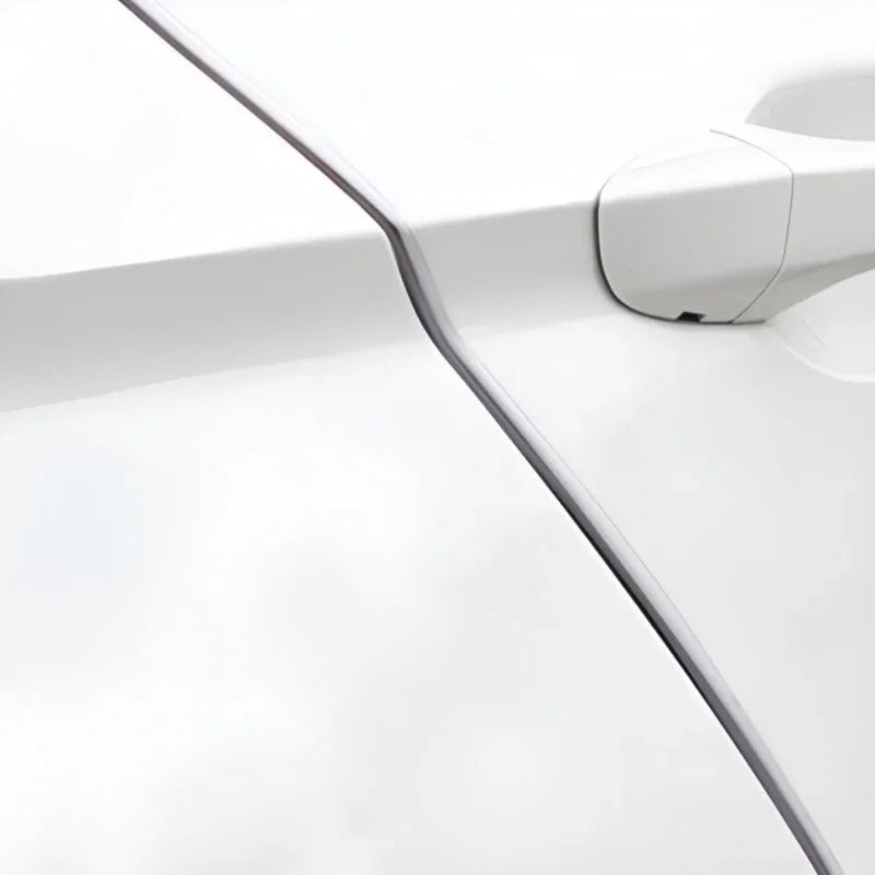 Close-up of a white automotive door handle and sleek body panel seam.