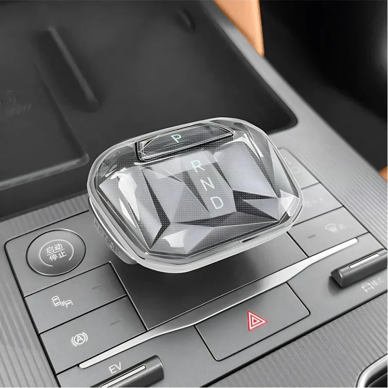 Transparent crystal gear shift knob cover for BYD car interior with diamond-cut design.
