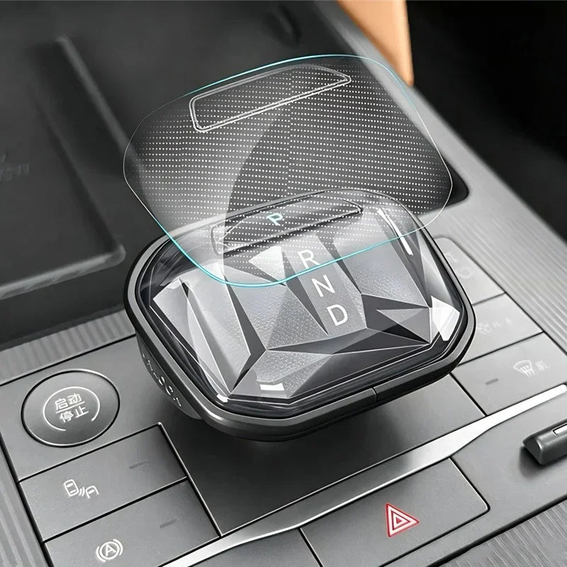Clear tempered glass protector for car gear shifter with a crystalline surface design.