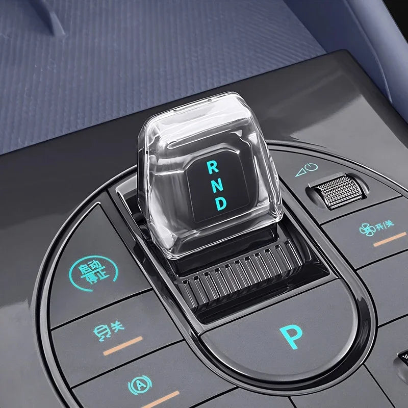 Crystal clear transparent gear shifter knob with glowing RND indicator for BYD interior.