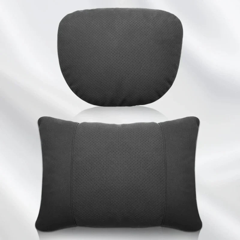 Two-piece perforated black faux leather car neck and lumbar support pillows.