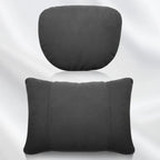 Two-piece perforated black faux leather car neck and lumbar support pillows.