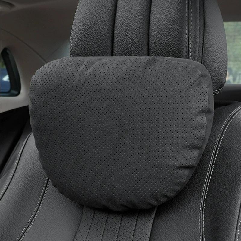 Professional grey perforated leather car headrest pillow for enhanced neck support.