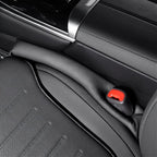 Black premium leather car seat with textured surface and red seatbelt buckle detail.