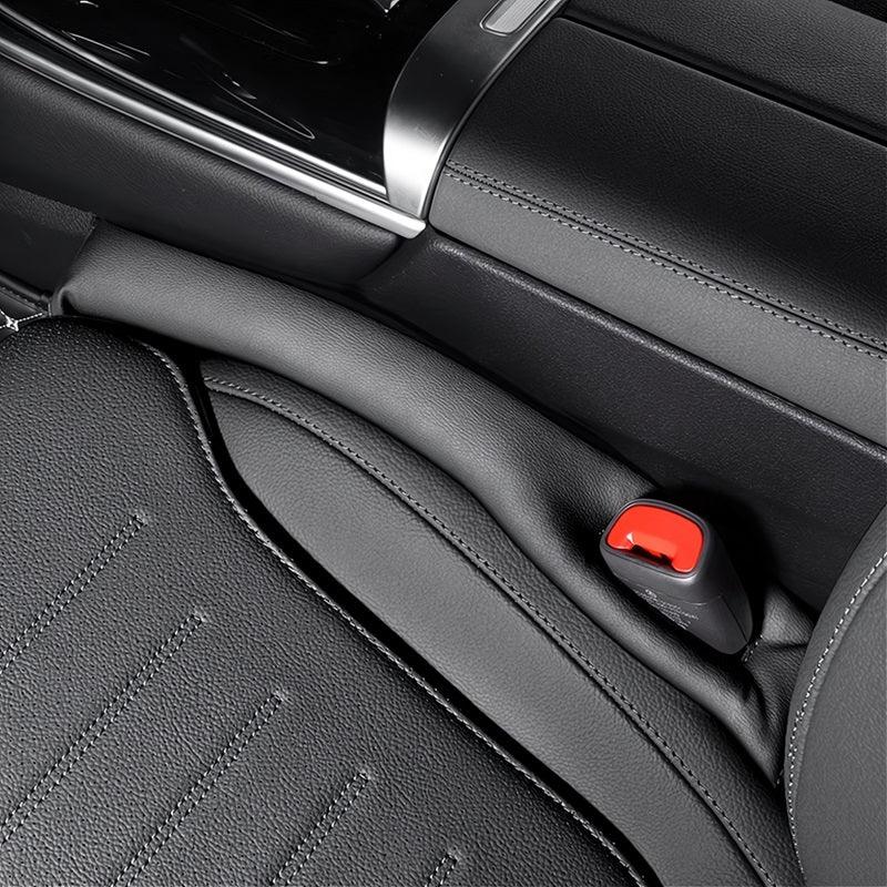 Black premium leather car seat with textured surface and red seatbelt buckle detail.