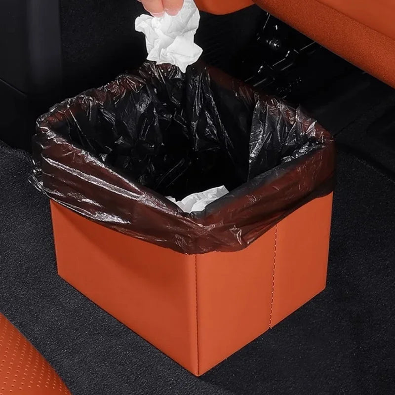 Brown leather car trash bin with black liner for organized vehicle interior storage.