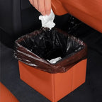 Brown leather car trash bin with black plastic liner for interior organization
