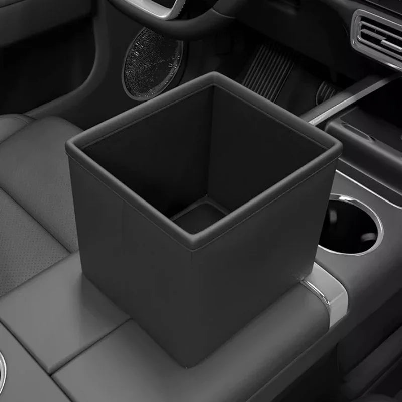Black leather car trash bin organizer installed in a vehicle center console