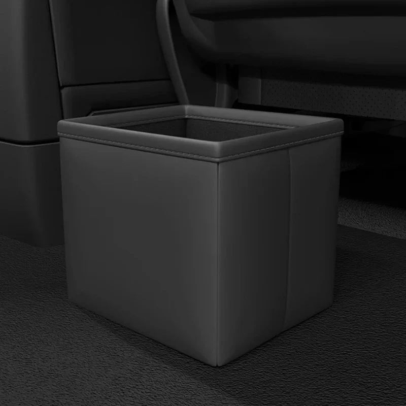 Black leatherette car trash bin with a mesh top for organized interior storage.