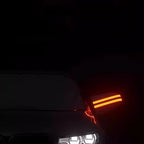 Glowing orange LED strip light accent on a dark car exterior at night.