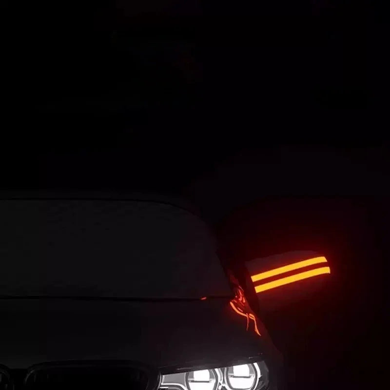 Glowing orange LED strip light accent on a dark car exterior at night.