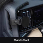 Black magnetic car phone mount with a sleek circular metal mount attached to the dashboard vent.