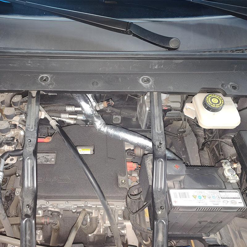 Protective silver thermal insulation wrap covering engine components for heat resistance.