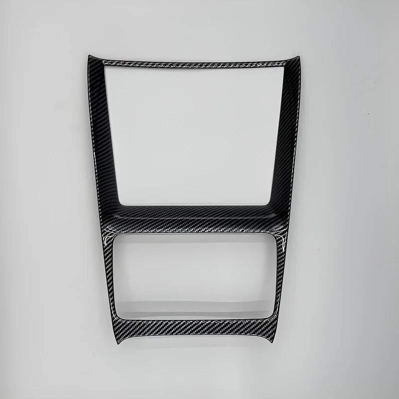 Black carbon fiber texture center console trim frame for BYD interior enhancement.