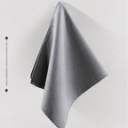 High-efficiency grey microfiber absorbent towel for car detailing and cleaning.