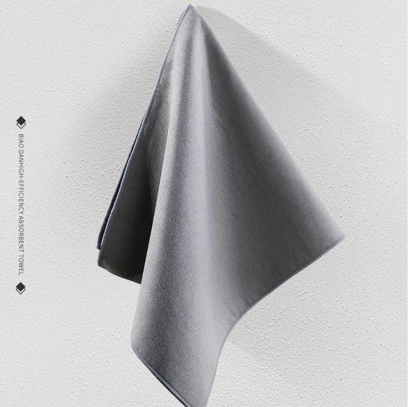 High-efficiency grey microfiber absorbent towel for car detailing and cleaning.