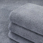 Stack of premium grey microfiber cleaning cloths with a soft, absorbent texture.