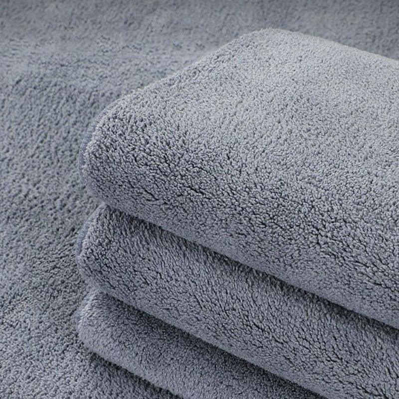 Stack of premium grey microfiber cleaning cloths with a soft, absorbent texture.