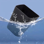 Black waterproof silicone car cup holder being splashed with water