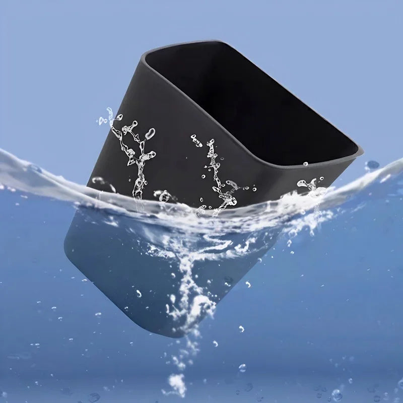 Black waterproof silicone car cup holder being splashed with water