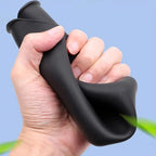 A hand squeezing a flexible black silicone material, demonstrating its soft and durable texture.