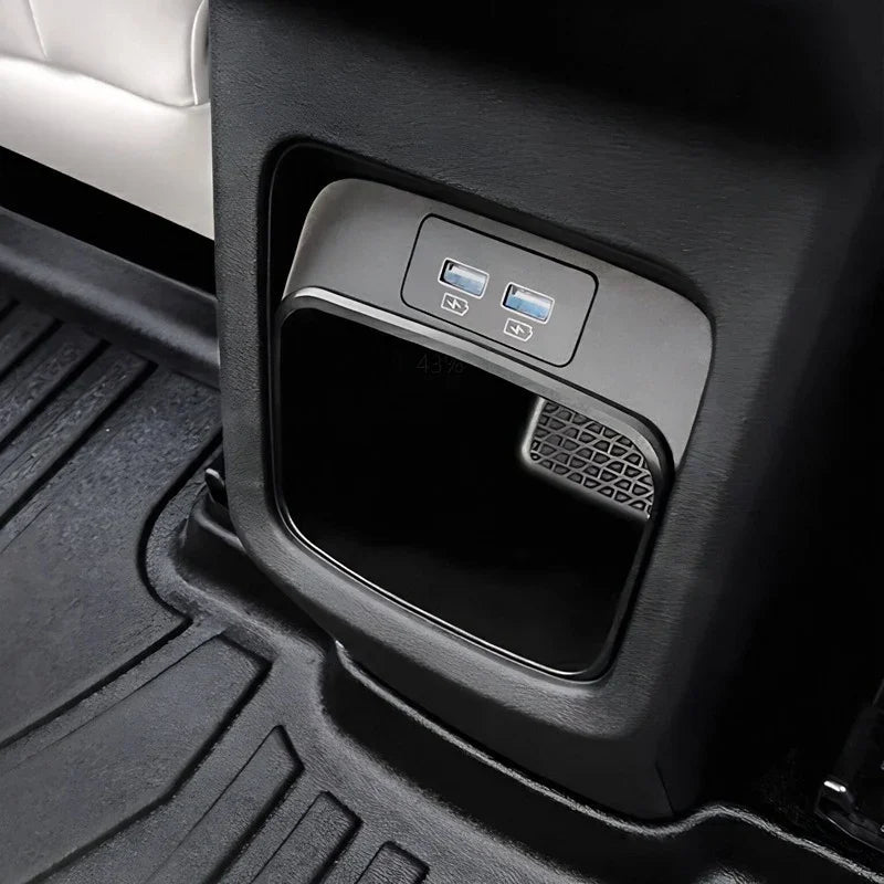 Close-up of a black interior console featuring dual USB charging ports and a digital display.