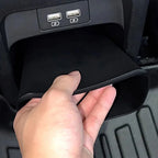 Black heavy-duty storage organizer being installed in a BYD car console with USB ports.