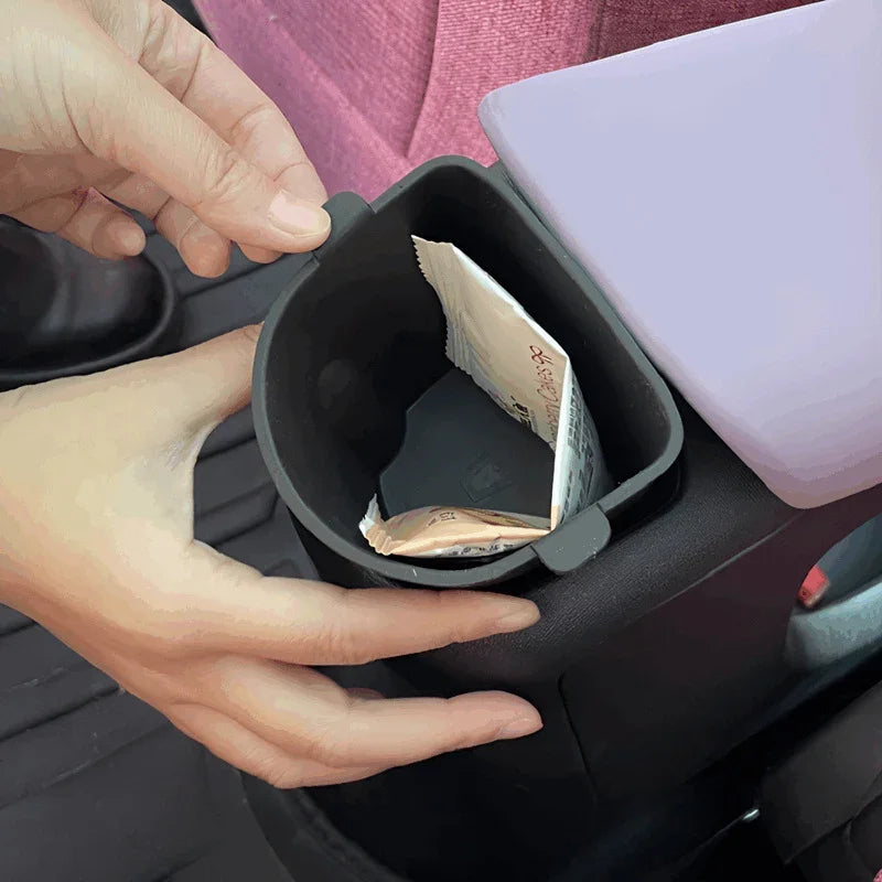 Black matte plastic car cup holder organizer with a convenient storage compartment.