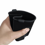 Hand holding a matte black silicone car cup holder insert with a custom divider design