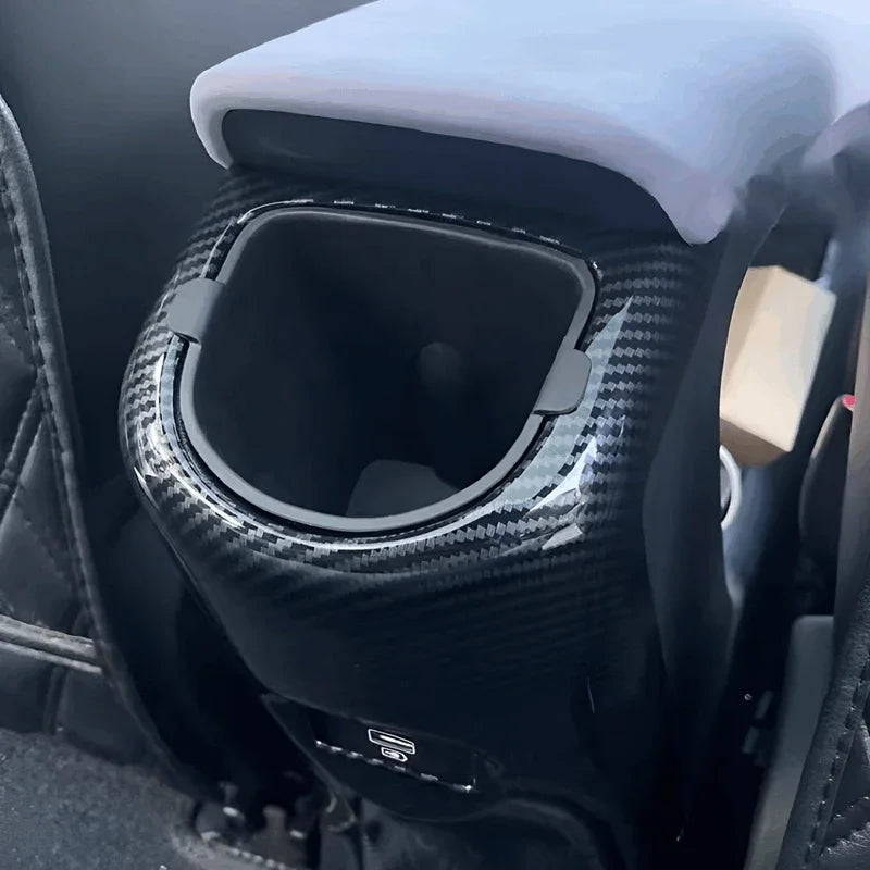 Carbon fiber center console cup holder trim in gloss black for BYD interior.