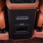 Carbon fiber rear center console trim in black for luxury car with brown leather interior