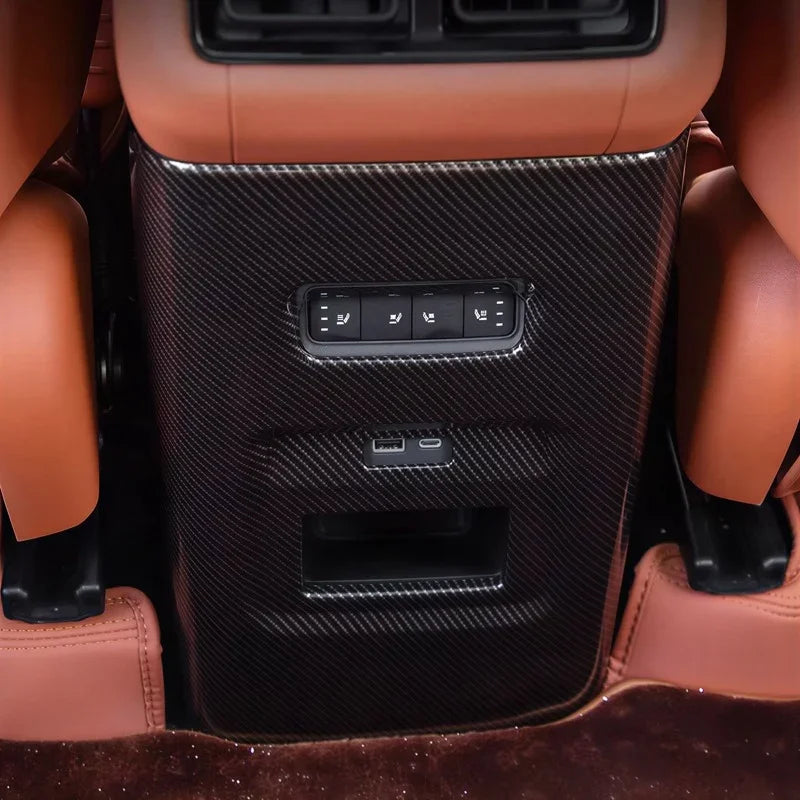 Carbon fiber rear center console trim in black for luxury car with brown leather interior