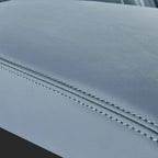 Close-up of premium light grey faux leather car seat with precise double-stitch detailing.