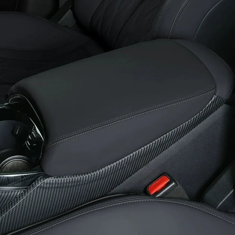 Black leather center console armrest with carbon fiber trim accents