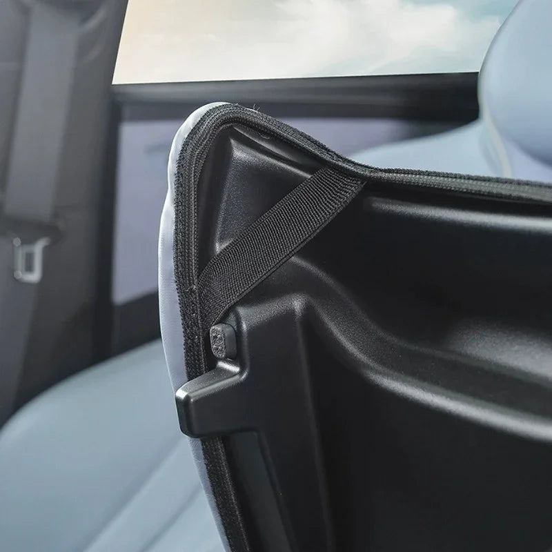 Close-up of a black durable fabric car seat back protector with reinforced stitching.