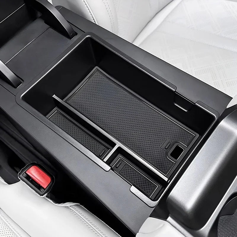 Black textured TPE center console organizer tray for car interior protection.