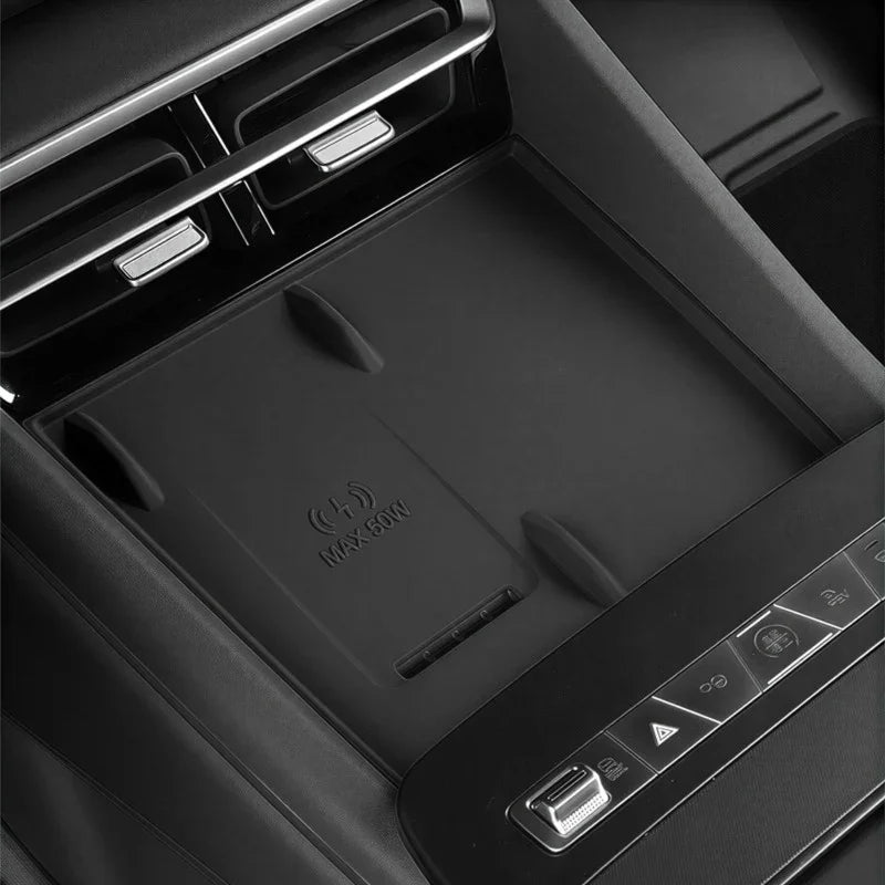 Black interior center console with a wireless charging pad marked MAX 50W.
