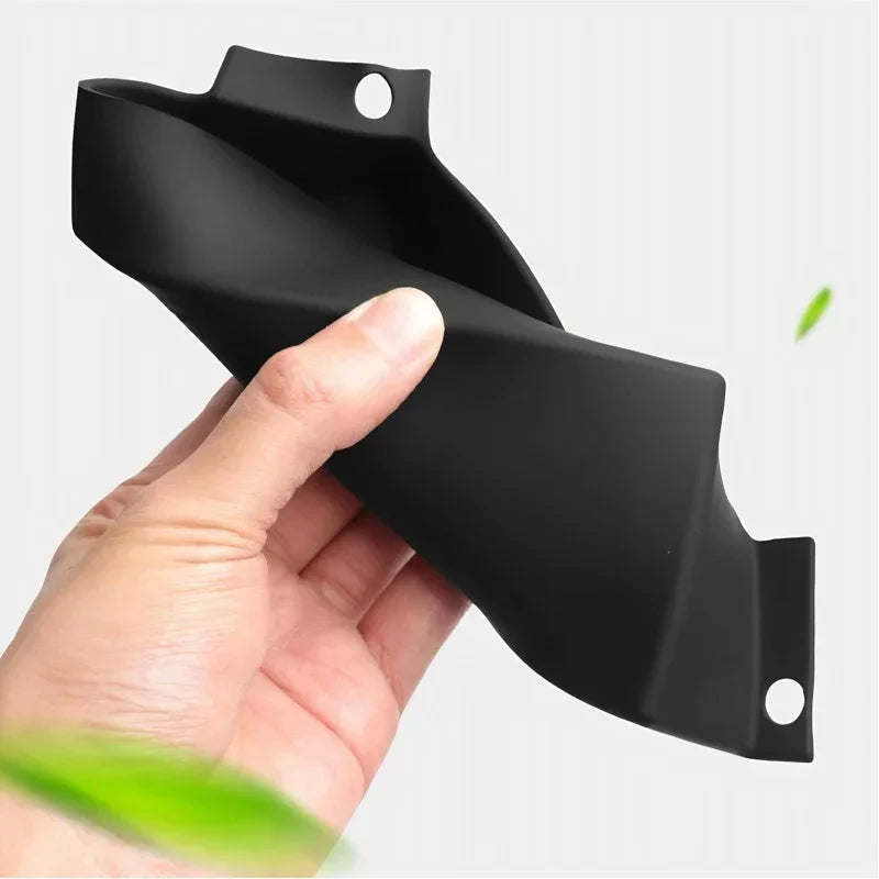 Black matte durable plastic automotive trim component held by hand.