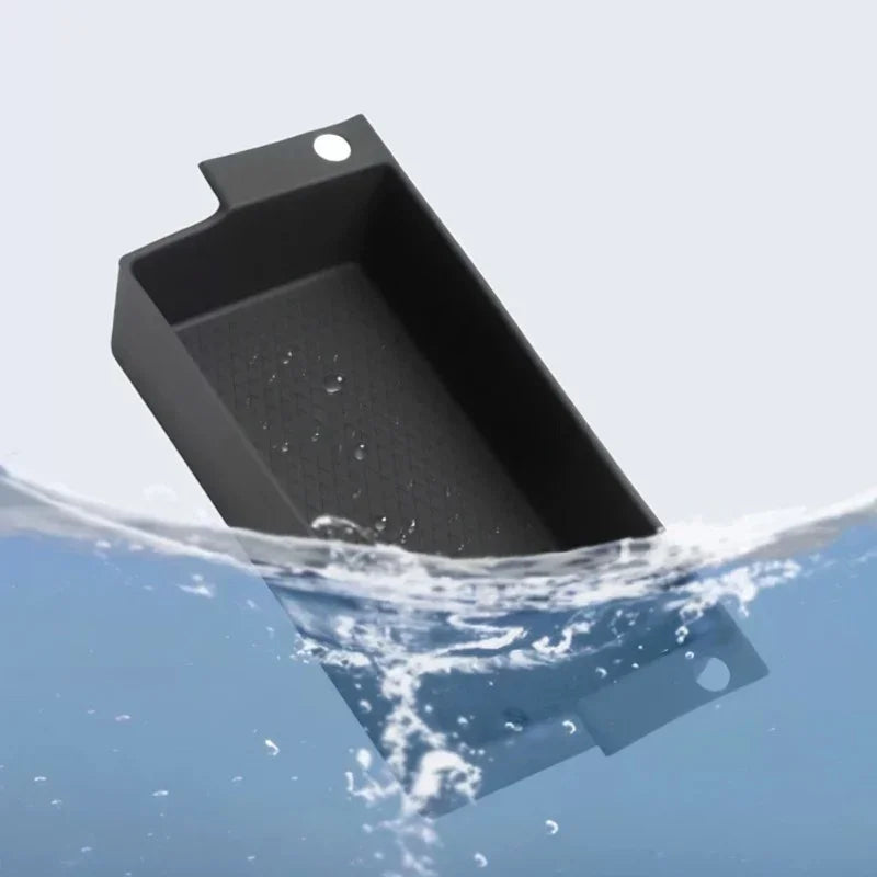 Waterproof black matte rubber car trunk tray partially submerged in water.