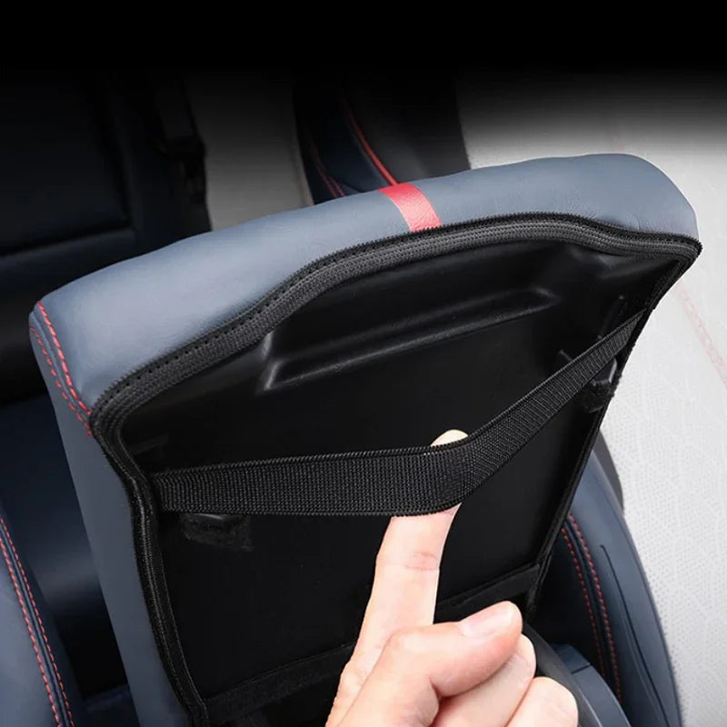 Grey faux leather car seat back organizer with red stitching and storage pocket.