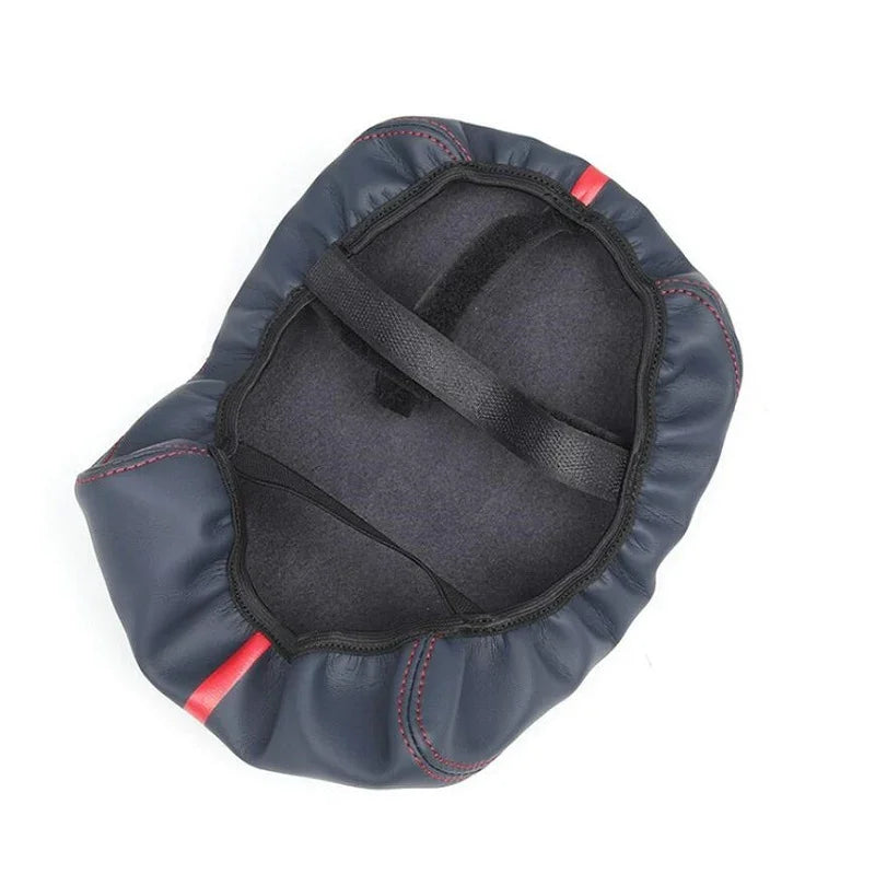 Dark grey faux leather car accessory with red stitching and interior strap