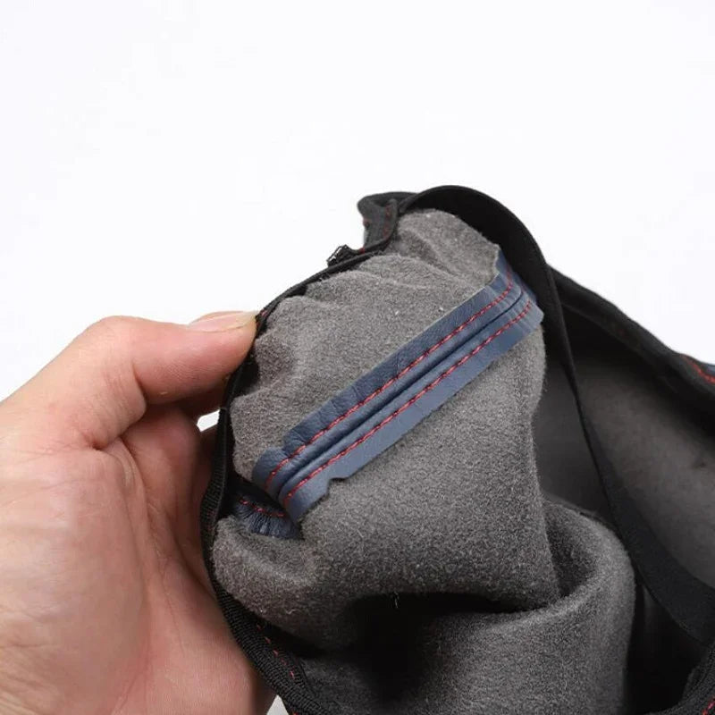 Close-up of grey soft-touch inner lining with durable red stitching for car accessories.