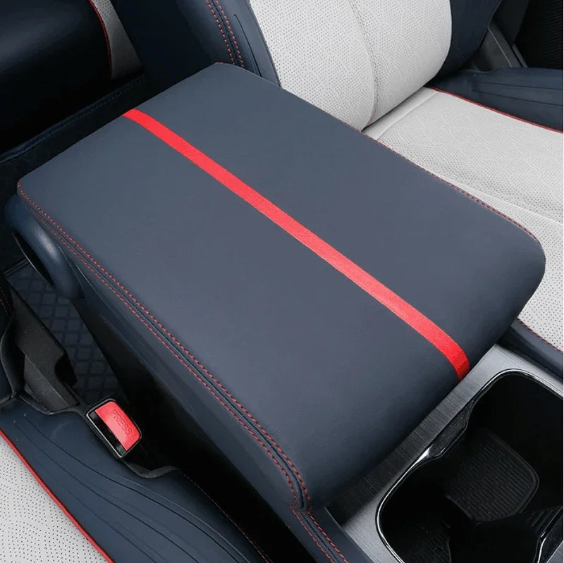 Navy blue leather center console cover with a red stripe and red stitching.