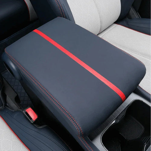 Navy blue leather center console cover with a red stripe and red stitching.