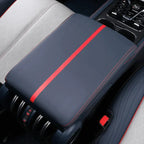 Premium black leather center console cover with a striking red racing stripe and red stitching.