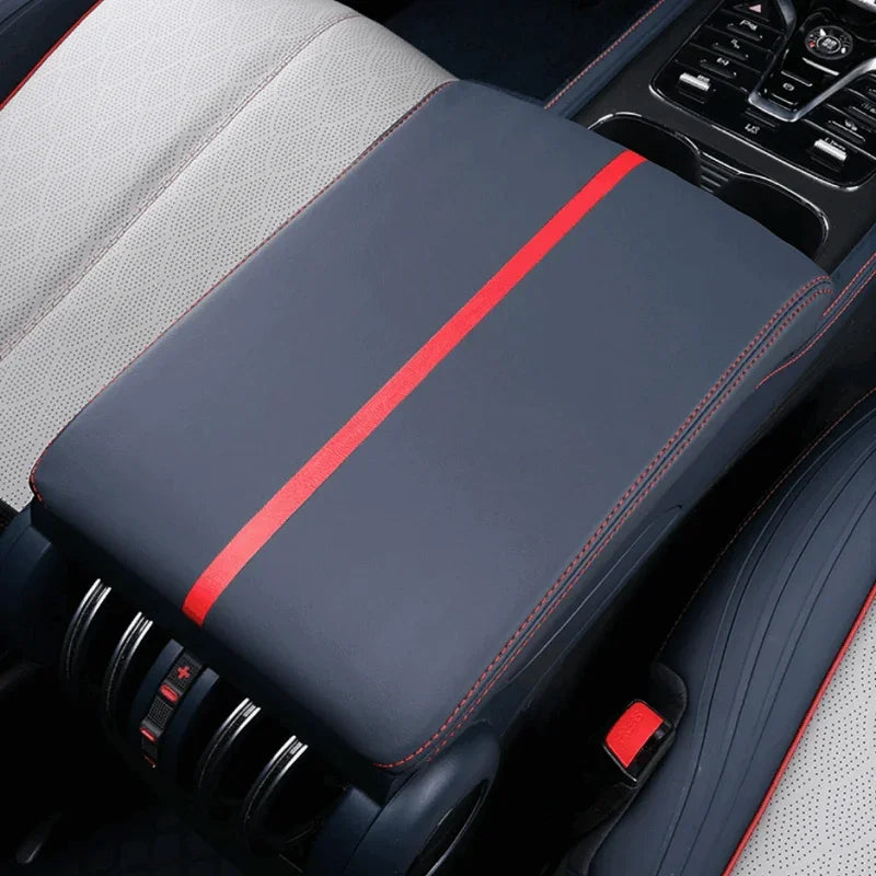 Premium black leather center console cover with a striking red racing stripe and red stitching.