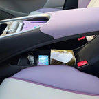Lavender and white leather car interior featuring a black center console storage compartment.