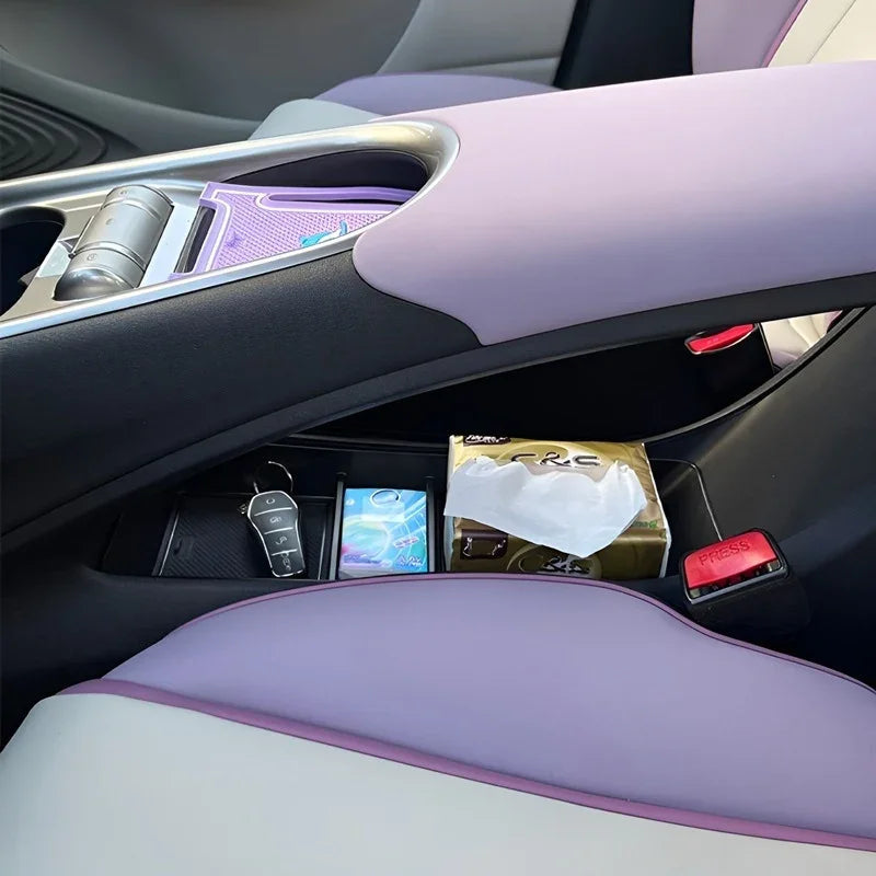 Lavender and white leather car interior featuring a black center console storage compartment.