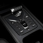 Black carbon fiber center console gear shift panel with professional sleek textured finish.